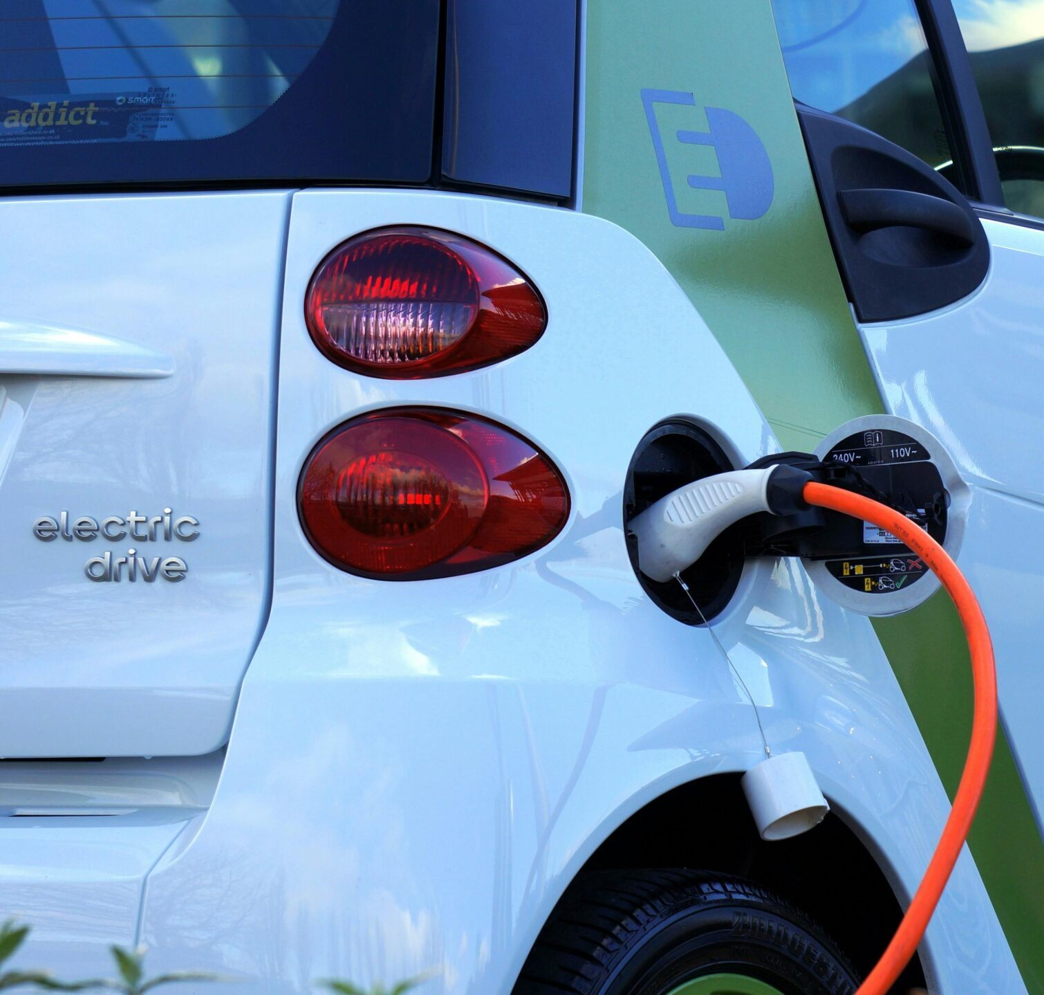 Close-up of an electric car being charged, highlighting eco-friendly transportation.